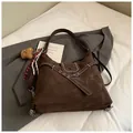 Dark brown retro hobo bag in suede finish with decorative straps and a plush bear charm - With Charm / Brown