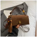 Dark brown underarm bag in suede and leather with gold buckle and tassel detail - With Charm / Frosted Brown