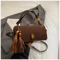 Dark brown suede and leather handbag with gold clasp, tassel charm and shoulder strap - With Charm / Matte Coffee