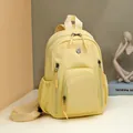 Primrose yellow nylon backpack with multi-pocket storage and adjustable straps - Goose Yellow