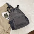 Dark grey waterproof drawstring sports backpack with large front zip pocket and mesh sides - Gray