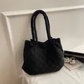Minimalist black quilted tote bag with padded handles and spacious diamond stitch design - Black