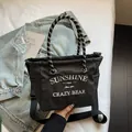 Canvas tote bag in black and white check pattern with embroidered sunshine text and strap - Black Small