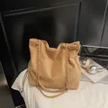 Brown suede tote bag with double shoulder straps and metal chain in daily setting - No Pendant / Khaki