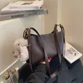 Dark brown tote bag with wrinkled texture, gold hardware, and a plush bunny charm - With Charm Style / Coffee with Pendant