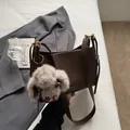 Dark brown leather shoulder bag with a plush rabbit charm in a cozy aesthetic setting - With Charm Style / Brown with Pendant