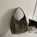 Green corduroy hobo shoulder bag with brown trim and front zipper pocket detail - Green
