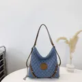 Quilted blue denim hobo tote bag with brown leather M logo and silver chain straps - Blue