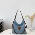 Light blue quilted fabric tote bag with brown leather straps and M logo patch - Light Blue
