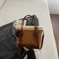 Brown suede tote bag with white faux fur trim and furry charm in a stylish setting - Brown with Pendant