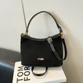 Black suede shoulder bag with contrast stitching and golden hardware on books - Black without Pendant