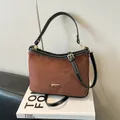 Deep brown faux suede shoulder bag with black leather trim and gold metal accents - Brown No Pendant