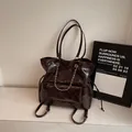 Deep brown quilted tote bag with chain strap and glossy vintage oil wax leather finish - Brown