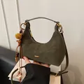 Olive green suede crescent handbag with gold hardware and wooden bead tassel - Green with Charm