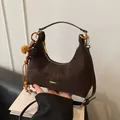 Dark brown hobo bag in matte suede leather with gold hardware and plush charm decoration - Brown with Pendant