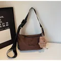 Dark brown suede shoulder bag with bear charm and adjustable strap for casual daily wear - Coffee With Ornament