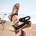 Bohemian black wedge sandals with braided straps and beaded charms in beach setting - EU 35 / Black