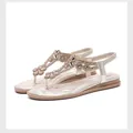 Detailed macro view of champagne gold sandals with rhinestones and quilted footbed - EU 35 / Light gold