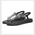 Detail of black rhinestone sandals featuring quilted footbed and crystal flower accents - EU 35 / Black