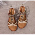 Detail view of Bohemian wedge sandals with colorful beads, heart charms and size 37 mark - Dark Brown