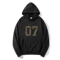 Oversized black hoodie featuring a leopard print number 07 and convenient kangaroo pocket - S / Black