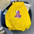 Detail of oversized yellow hoodie featuring a purple cartoon bear print and drawstrings - S / Yellow
