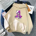 Detail of oversized beige hoodie featuring purple graphic bear and drawstring hood - S / Apricot