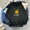 Detail of sunflower print and be kind slogan on a black fleece hoodie with pocket - S / Black