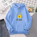 Close-up of light blue hoodie featuring sunflower print and kangaroo pocket detail - S / Sky Blue