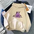 Detail of apricot oversized hoodie featuring cartoon bear print and front pocket on blue stool - S / Apricot