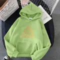 Oversized light green hoodie featuring a bold orange eye triangle graphic and kangaroo pocket - S / Grass Green