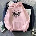 Close-up of pink oversized hoodie showing MAMA heart print and soft cotton texture - Dark Pink
