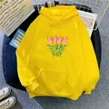 Detail shot of oversized yellow hoodie featuring a minimalist pink tulip print and kangaroo pocket - Yellow