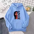 Détail d'un sweat à capuche bleu clair avec texte Shine et illustration de portrait - S / Bleu ciel
