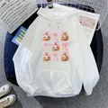 White oversized hoodie with pink bows and pumpkin print on a flat lay aesthetic background - S / White