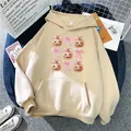 Beige oversized drawstring hoodie featuring festive pumpkin and pink bow graphics - S / Apricot