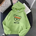 Close-up of light green hoodie featuring a rainbow bear graphic and kangaroo pocket - S / Grass Green