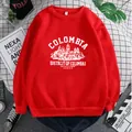 Detailed view of red crewneck sweatshirt with white vintage Colombia print on plaid background - S / Red