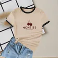 Damen T-Shirt in Aprikose mit Kirschprint, schwarzen Kontrastkanten und lockerem Schnitt - S / Khaki mit schwarzem Besatz