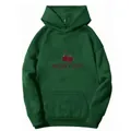 Close-up of dark green hoodie featuring cherry print and Monties text on chest - S / Dark Green
