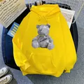 Close-up of a yellow hoodie featuring a geometric bear print and a front kangaroo pocket - M / Yellow