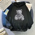 Close-up of black oversized hoodie featuring a low-poly bear print and kangaroo pocket - M / Black