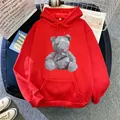 Detail of red fleece hoodie featuring a geometric bear print and front kangaroo pocket - M / Red