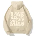 Beige oversized fleece hoodie for women with LOVE NEVER FAILS back print design - S / Apricot
