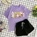 Flat lay of purple short-sleeve T-shirt with anime print and black drawstring shorts set - M / Violet