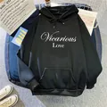 Flat lay of black hoodie with Vicarious Love print and kangaroo pocket detail - S / Black