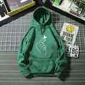 Close-up of dark green hoodie featuring white finger heart print and ribbed cuffs - Dark Green