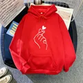 Detail of red oversized hoodie featuring heart gesture print and soft cotton fabric texture - Red