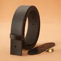 Detailed view of dark brown cowhide leather belt strap with solid brass fixing screws - 105 / Black