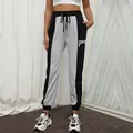 Pantalón deportivo bicolor negro y gris con texto Courage y cordón ajustable - S / Negro y Gris